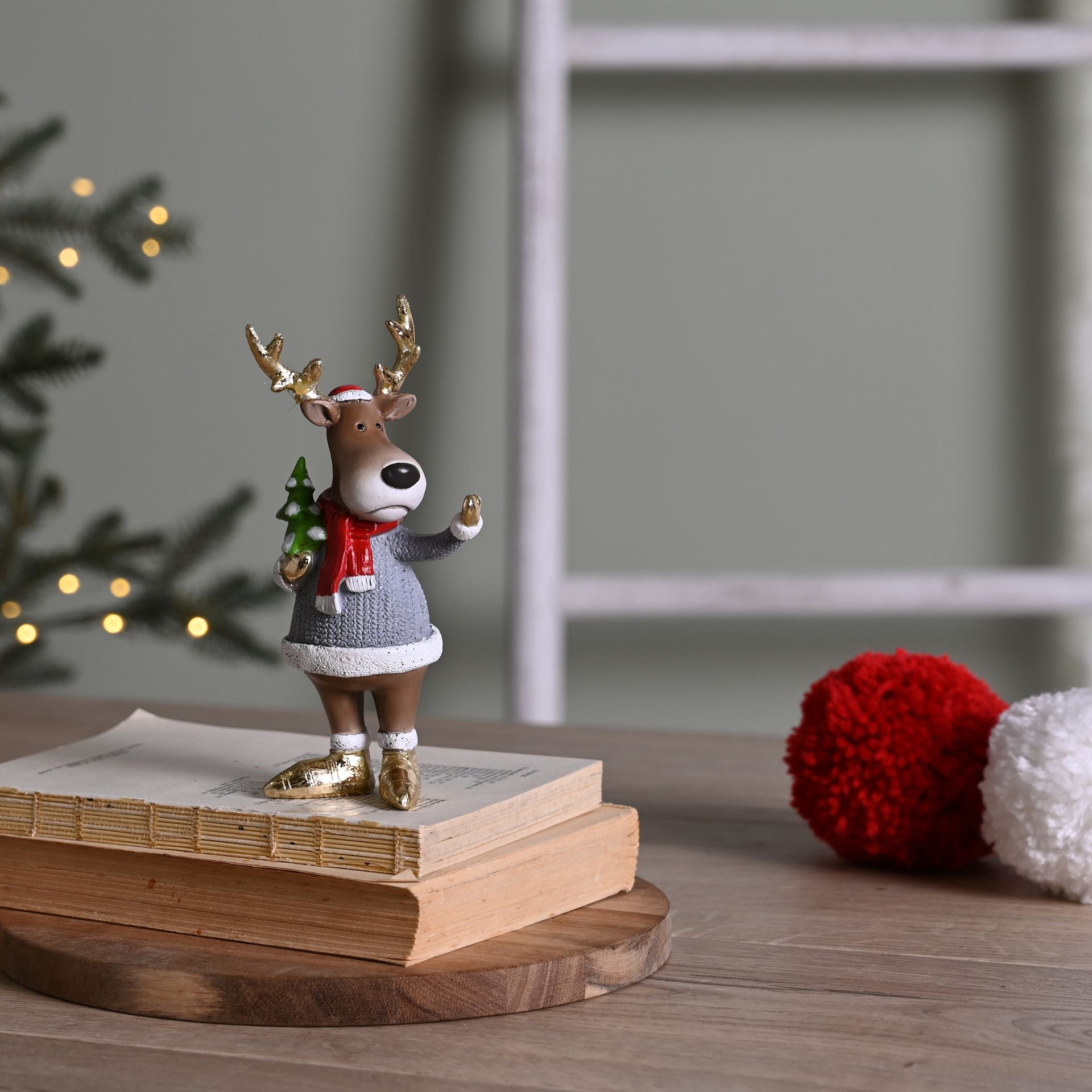 Decorative reindeer figurine on books with a blurred background