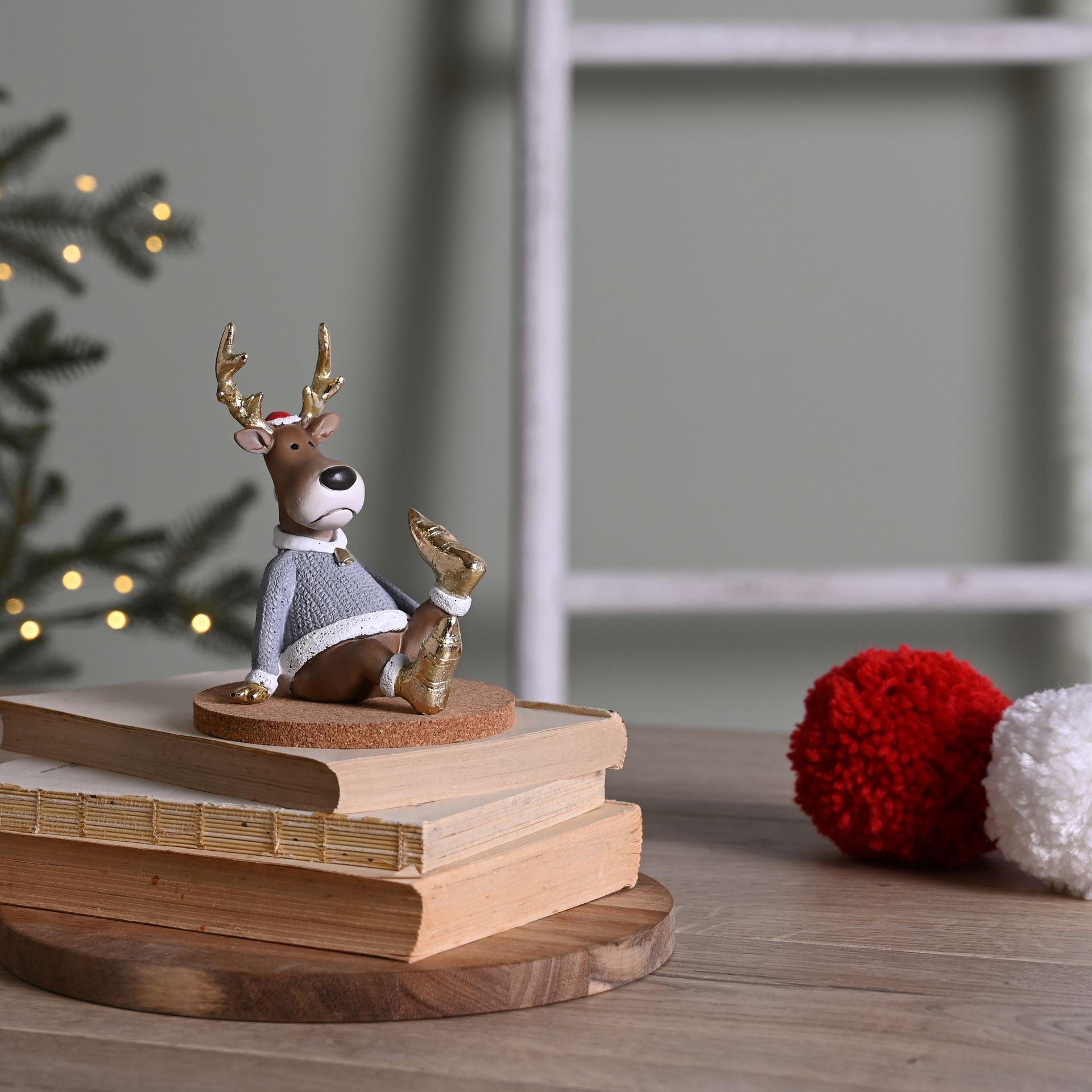 Decorative reindeer figurine on books with a blurred background