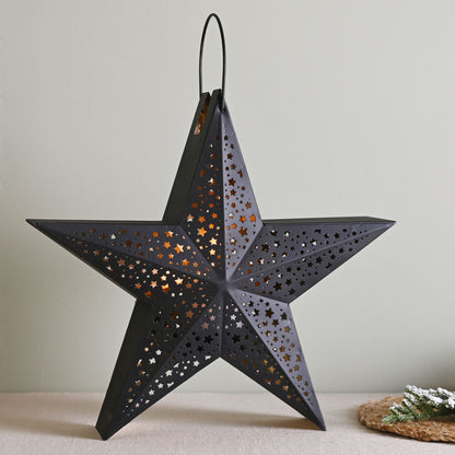 Black star-shaped lantern on a neutral background