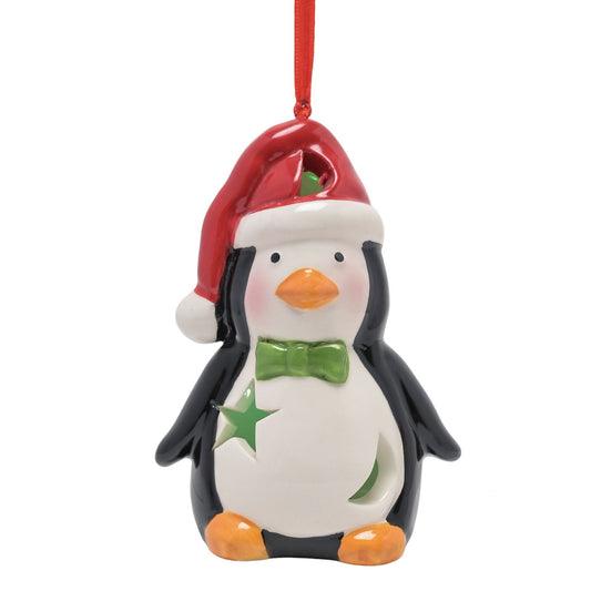 Christmas ornament shaped like a penguin wearing a Santa hat and green bow tie on a white background.