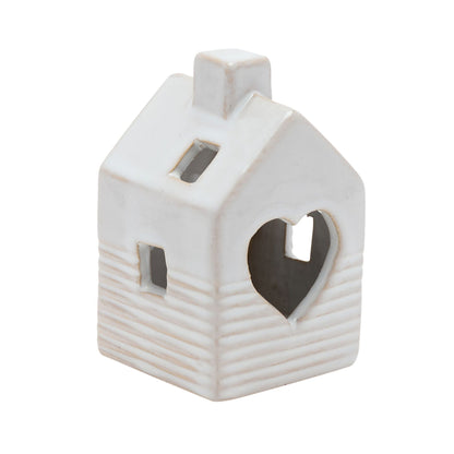 Ceramic house-shaped lantern with a heart cutout on a white background