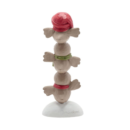 Stack of three ceramic figurines with colorful hats on a white background
