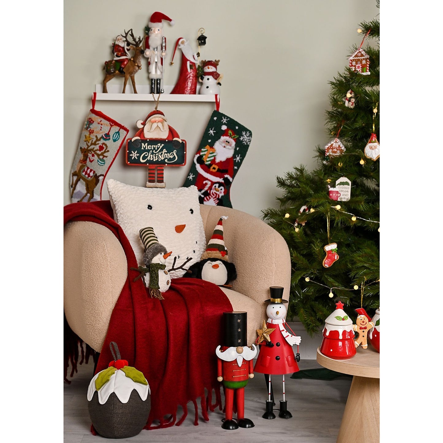 Christmas-themed room with stockings, tree, and decorative items.