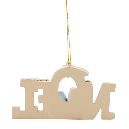 Decorative ornament shaped like the word Noel, hanging from a gold chain on a white background.