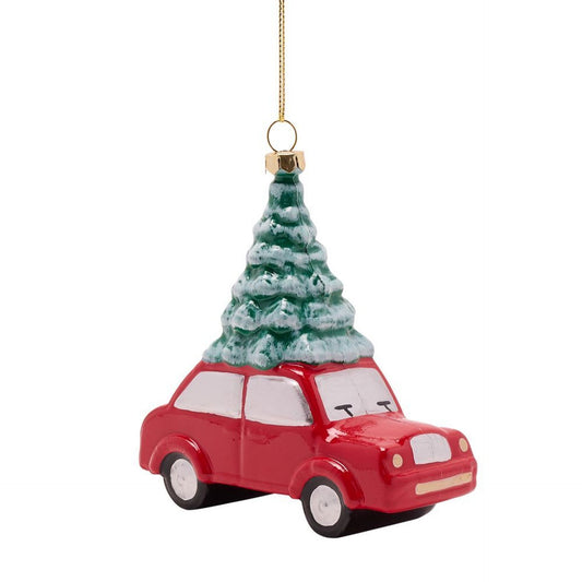 Red car ornament with a Christmas tree on top against a white background
