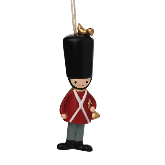 Decorative ornament of a soldier in red uniform with black hat on a white background