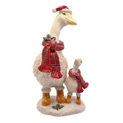 Decorative goose figurine with a red scarf and Santa hat on a white background