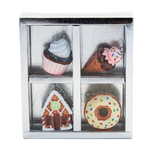 Set of four miniature dessert figurines in a clear display case on a white background